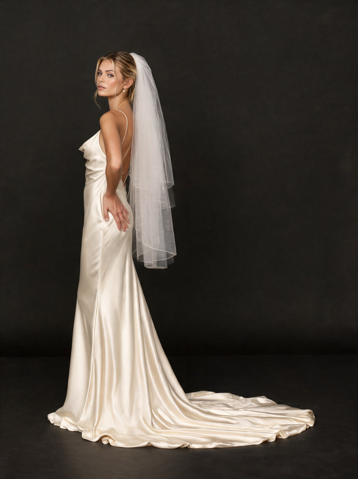 Ivory two-tier veil with an ivory satin dress
