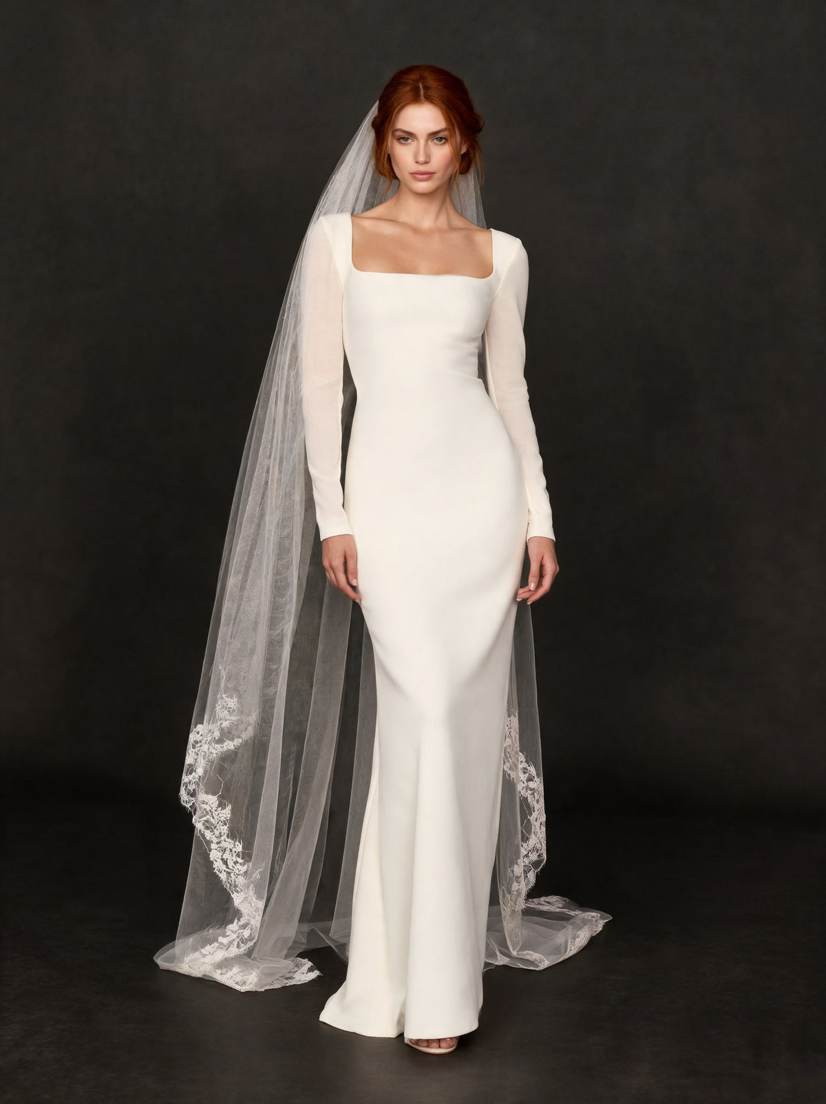 Off white veil with lace edge and an off white crepe dress