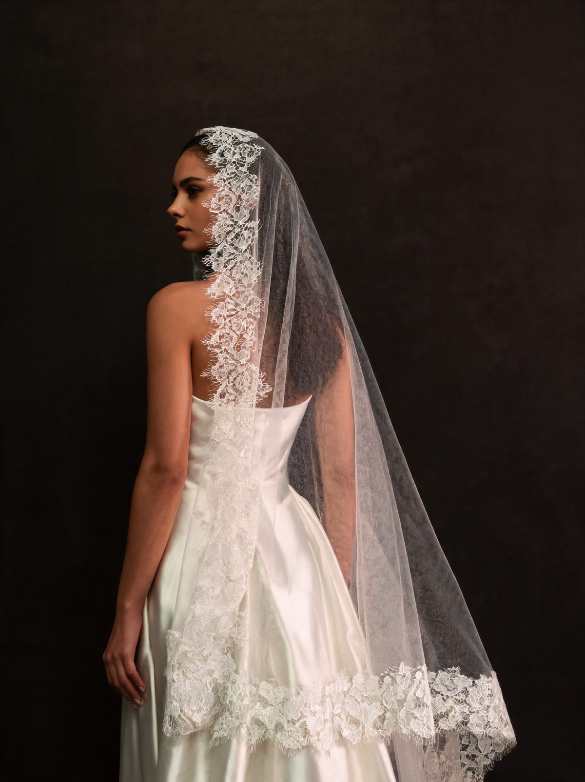 Fingertip length lace mantilla veil, side view