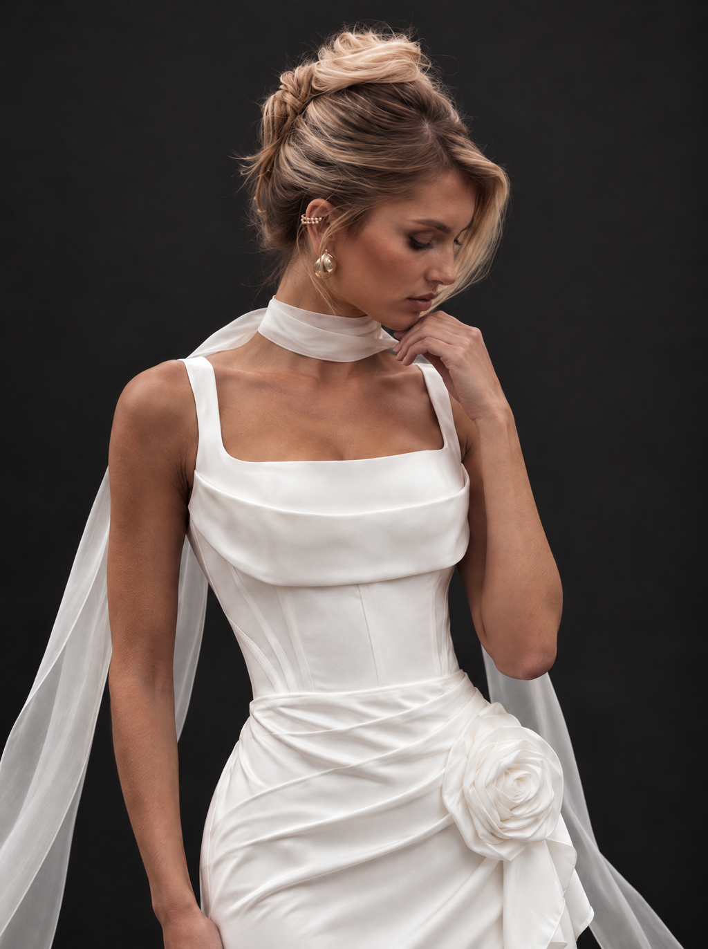 The Elowen veil — bride adjusting the chiffon neck scarf
