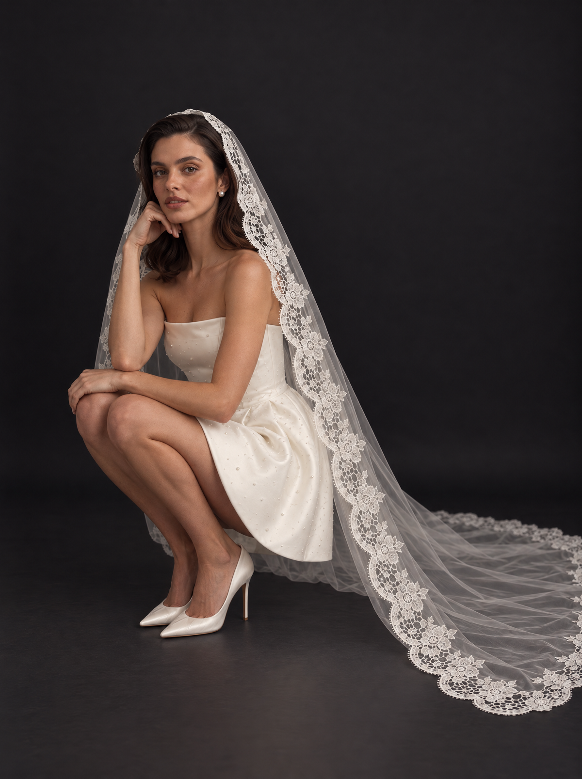 The Liora veil — bride kneeling with the veil spread around her