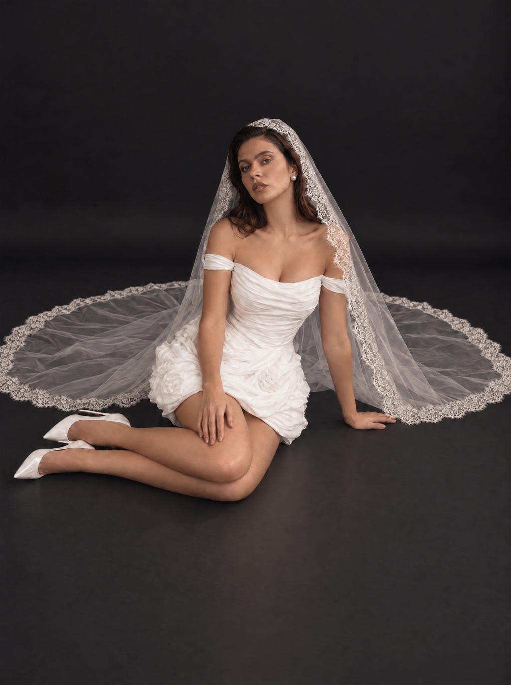 The Camille veil — bride seated with the veil spread on the floor