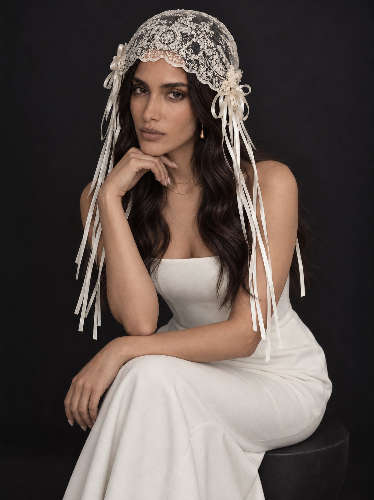 The Amara veil — bride seated in the lace cap veil